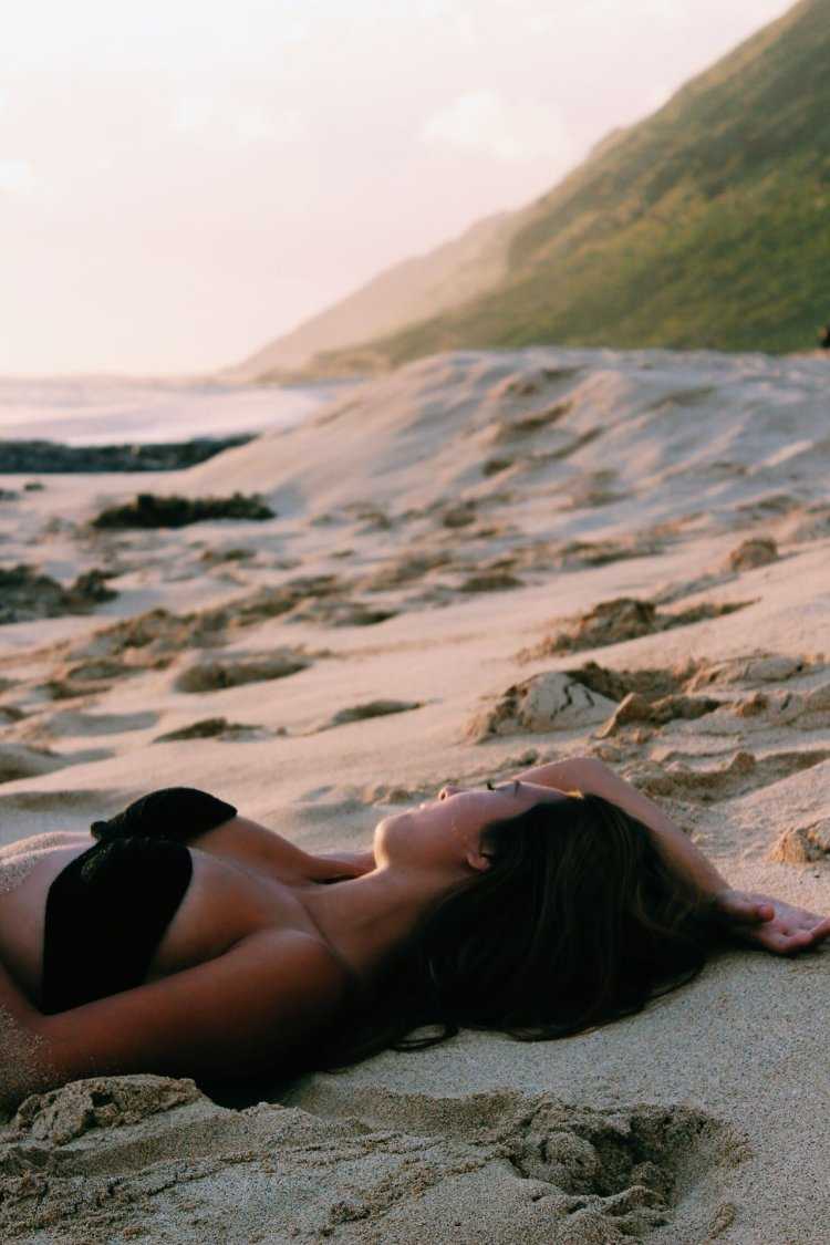 Брюнетка на море со спины